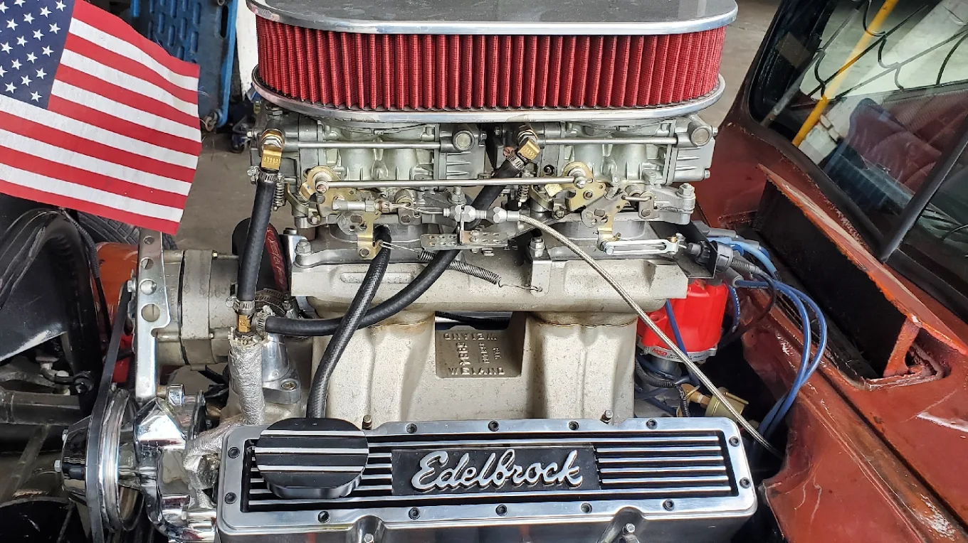 Edelbrock dual-quad setup with American flag — built at Alamilla's Carburetors